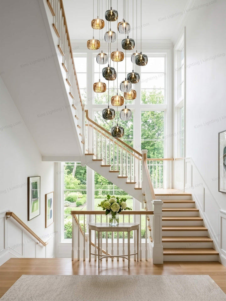 Glass staircase chandelier enhances a modern tall interior beautifully.