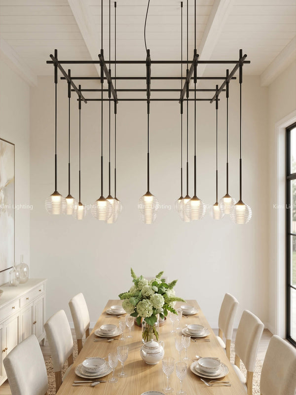 A glass pendant chandelier enhances a dining room with luxurious rectangular lighting.