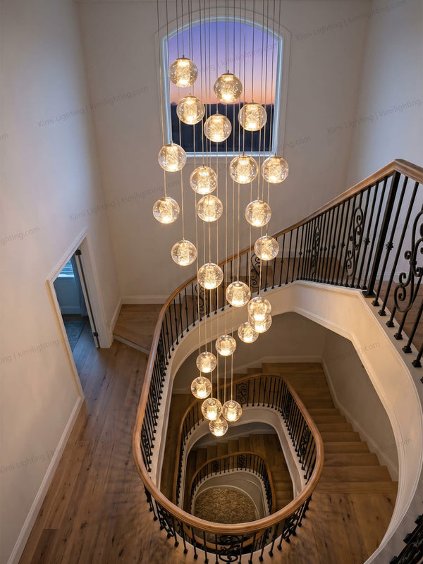 Crystal bubble staircase chandelier creates elegant lighting in tall interiors.