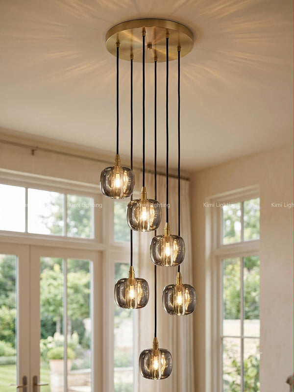 Elegant glass pendant light creates warmth in a dining room.