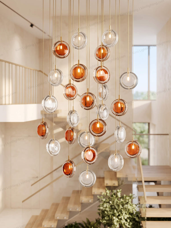 Minimalist lens chandelier enhances elegant double-height staircase lighting.