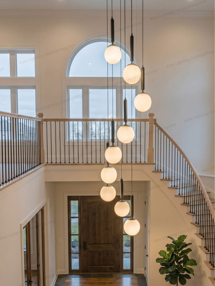 A round glass pendant lamp decorates a modern entryway elegantly.