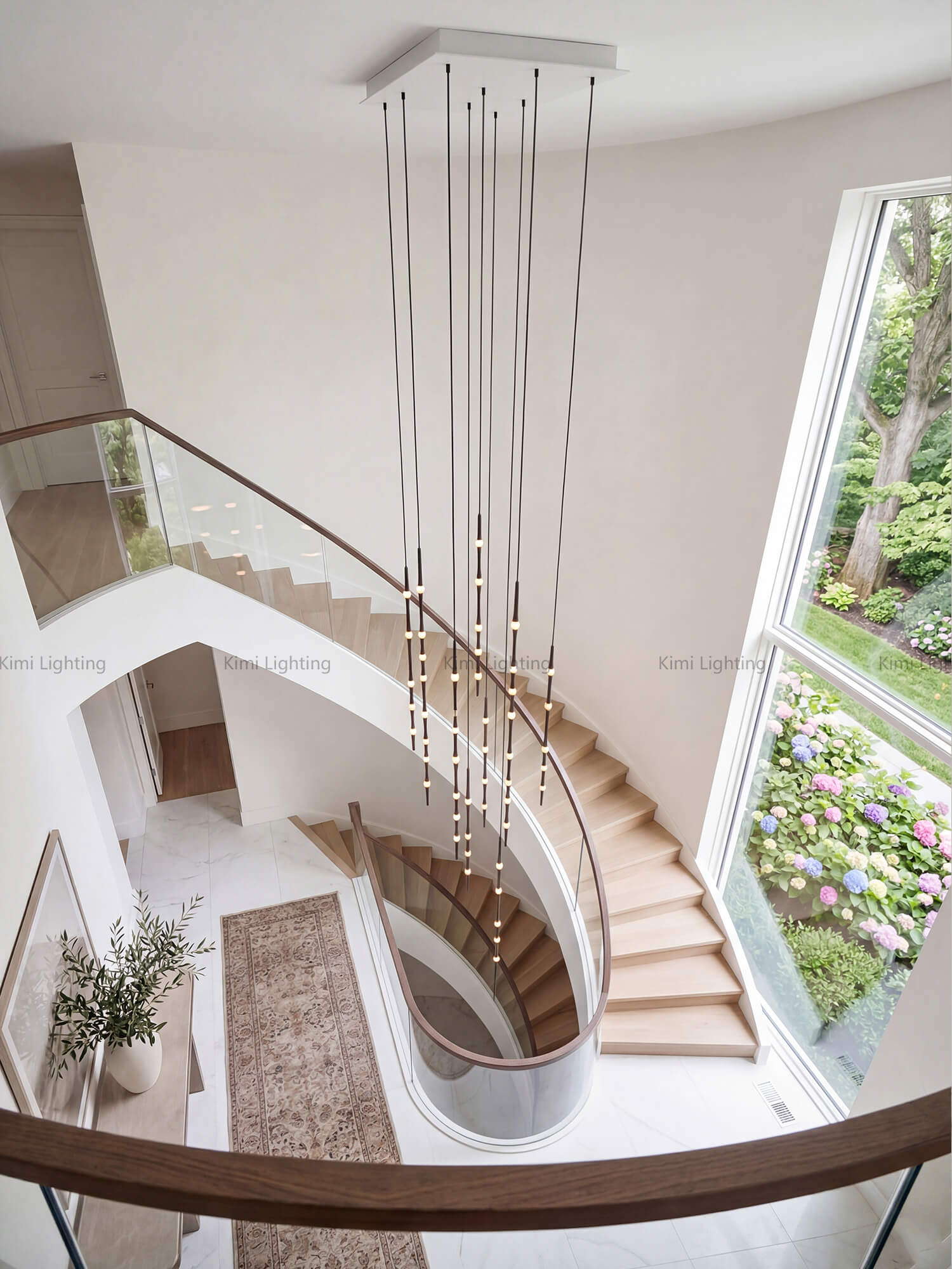 Dew drop pendant chandelier centered in a spiral staircase